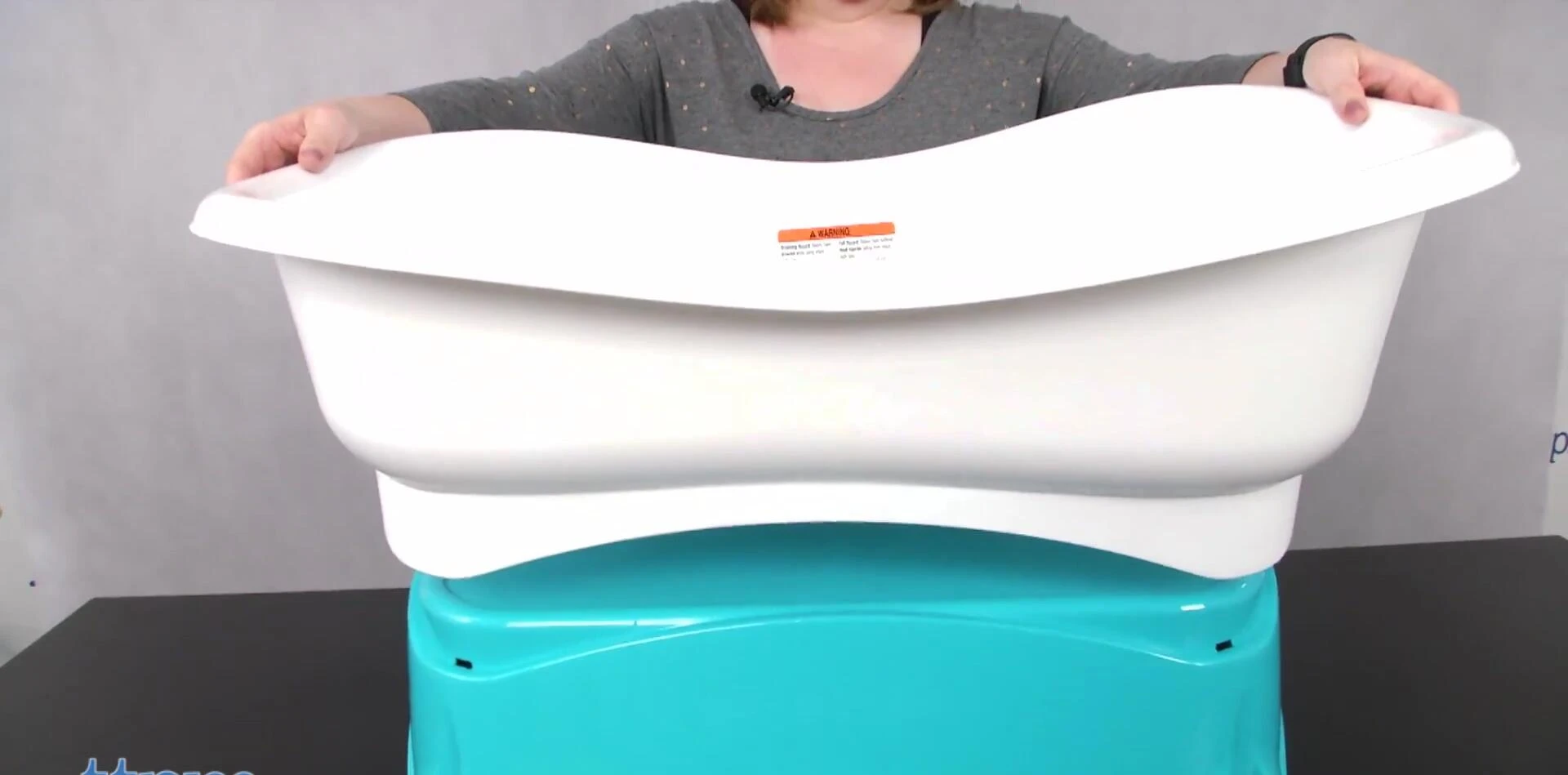 The elevated baby bathtub at a comfortable height for parents.