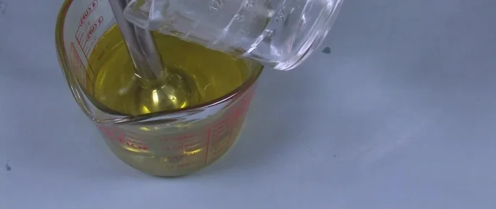 Carefully pour the lye water mixture down the shaft of the stick blender into the oils. Pulse the stick blender and stir until a thin trace is reached.