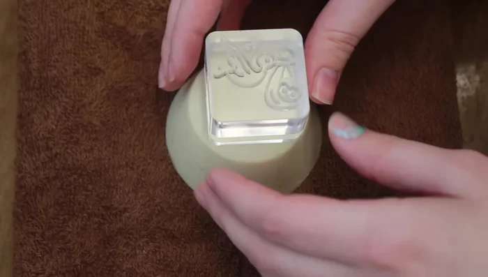 Stamp Soaps: Gently tap the soap stamp into each bar using a rubber mallet or hammer. 