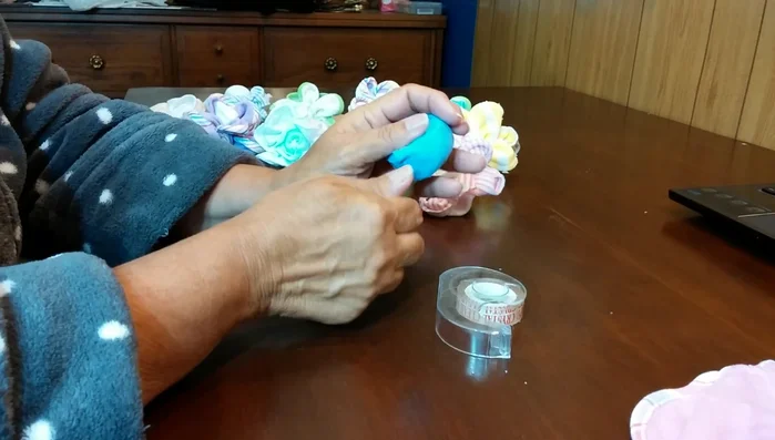 Attach the rolled washcloth to the plastic silverware, ensuring the seam is at the bottom.