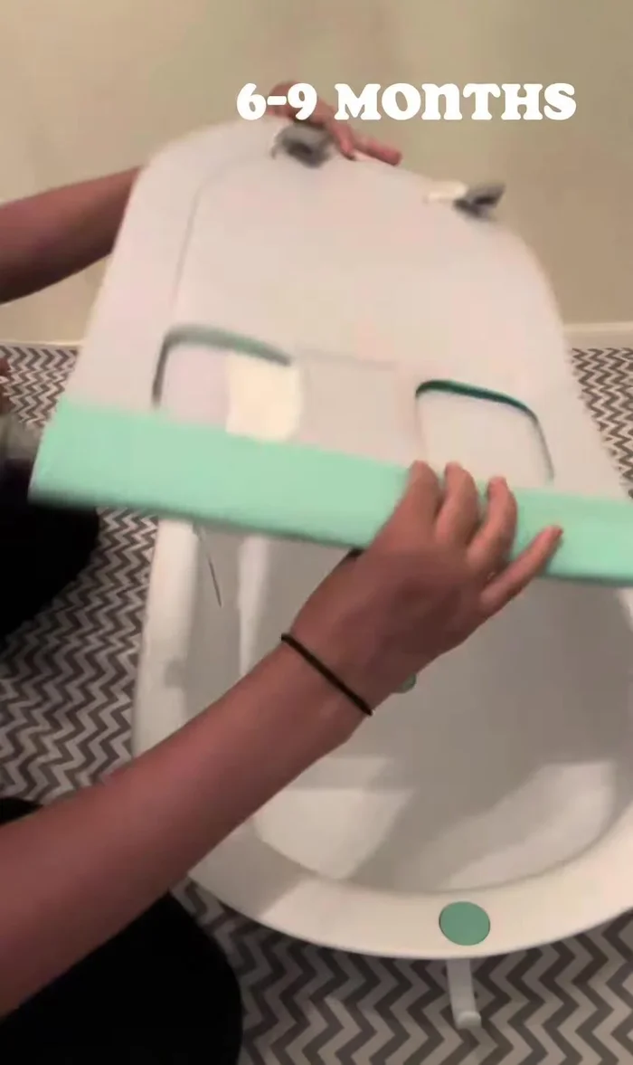 6-9 Months: Use the opposite end of the tub, reattach the hooks, flip the seat over (gray side up), and use the designated slot.