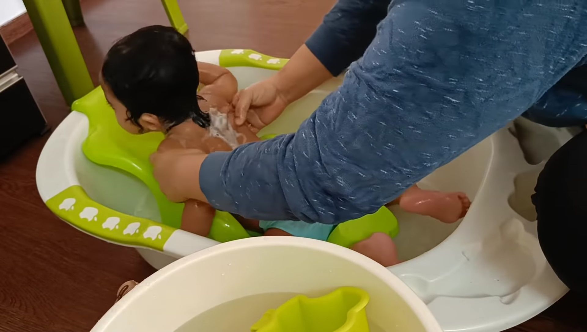 Baby in the tub lying on its back.