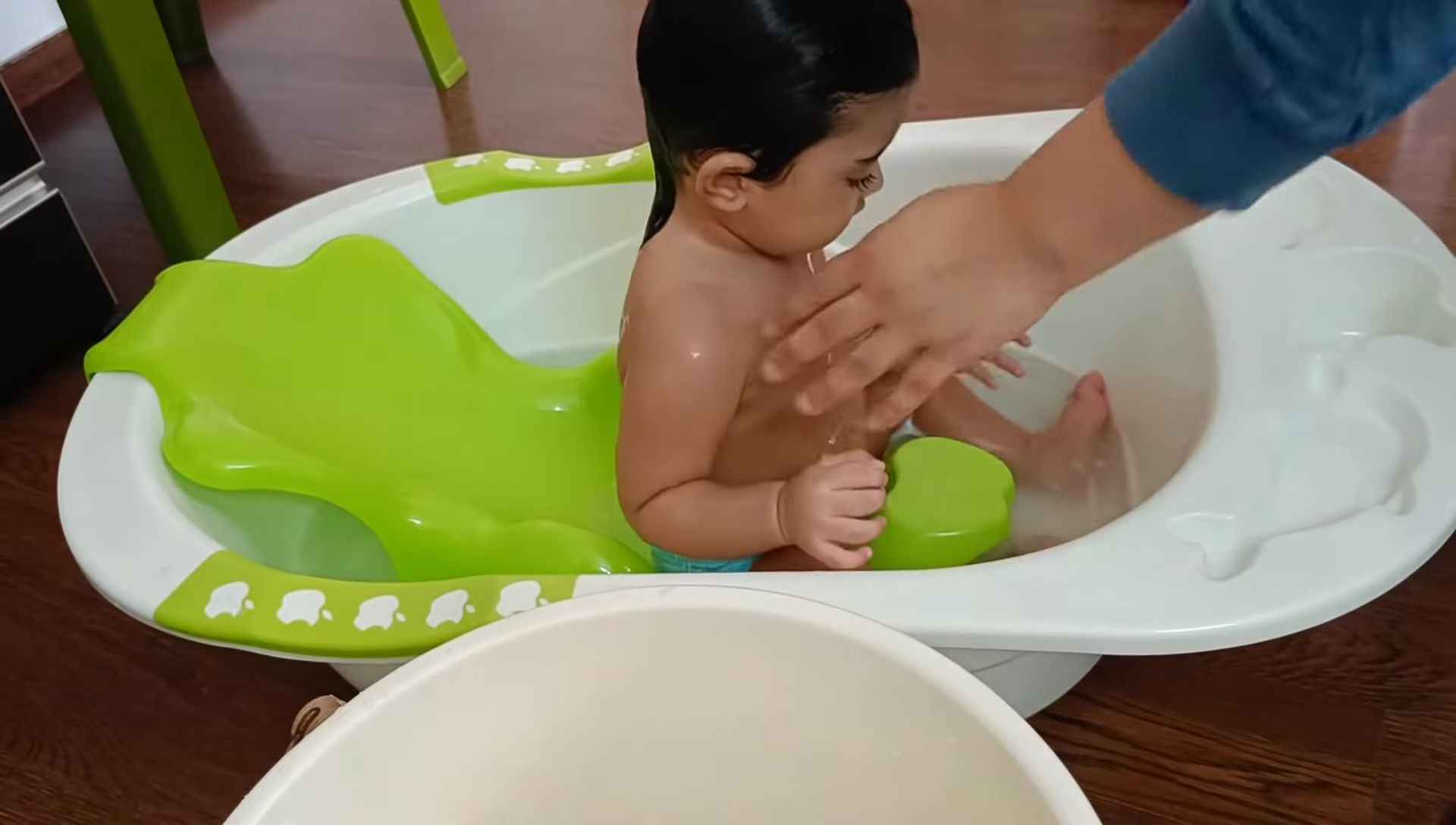 Baby sitting comfortably in the tub