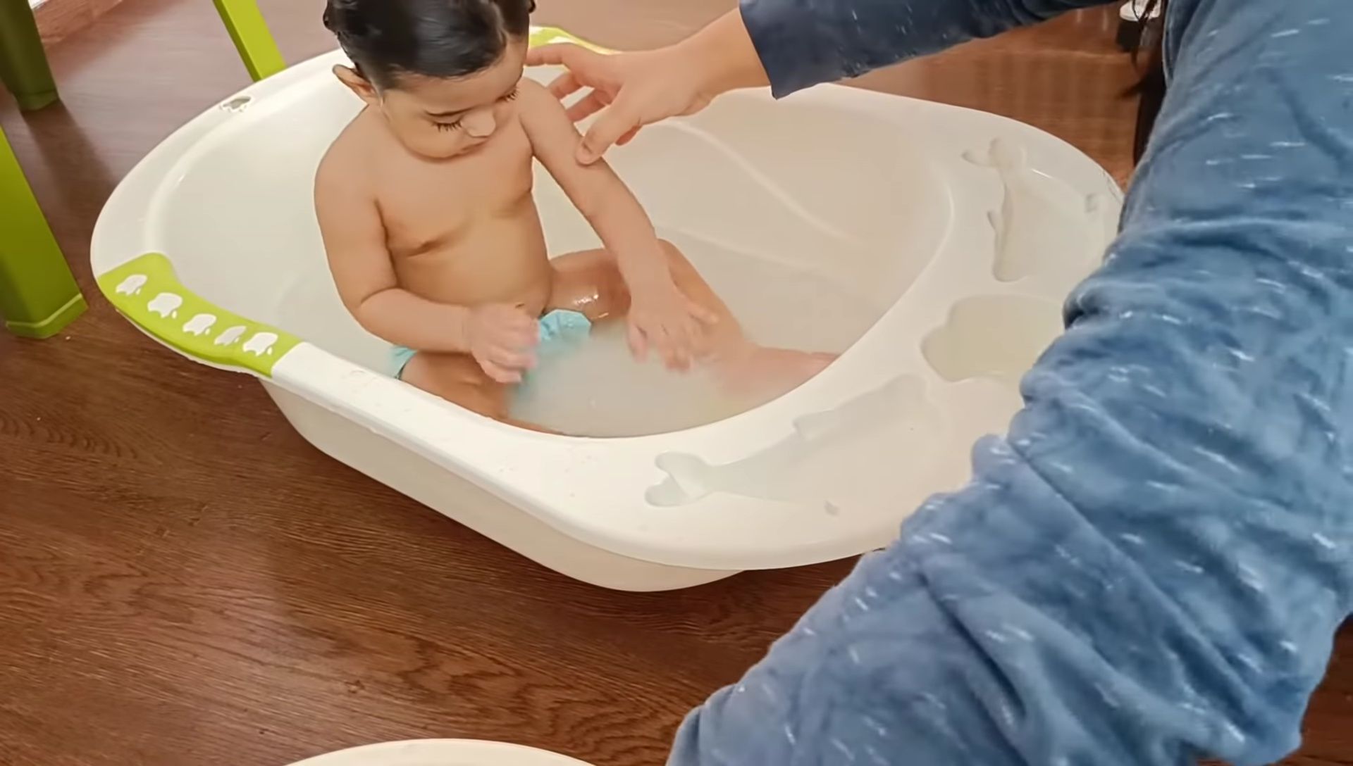 Baby in the tub in a different position.