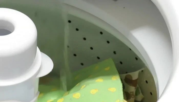 Run the washing machine through a complete cycle.