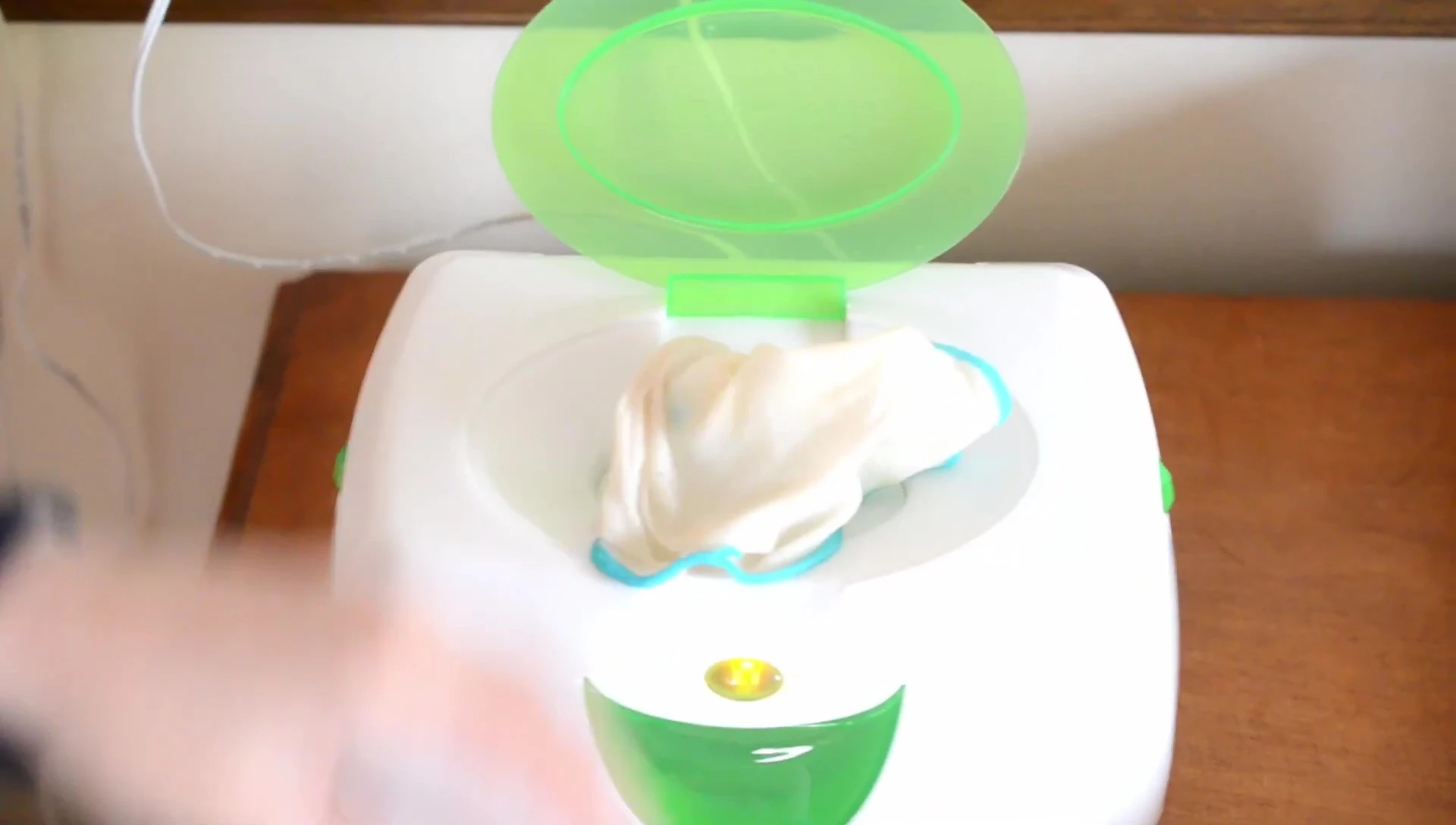 Removing a wipe from the warmer