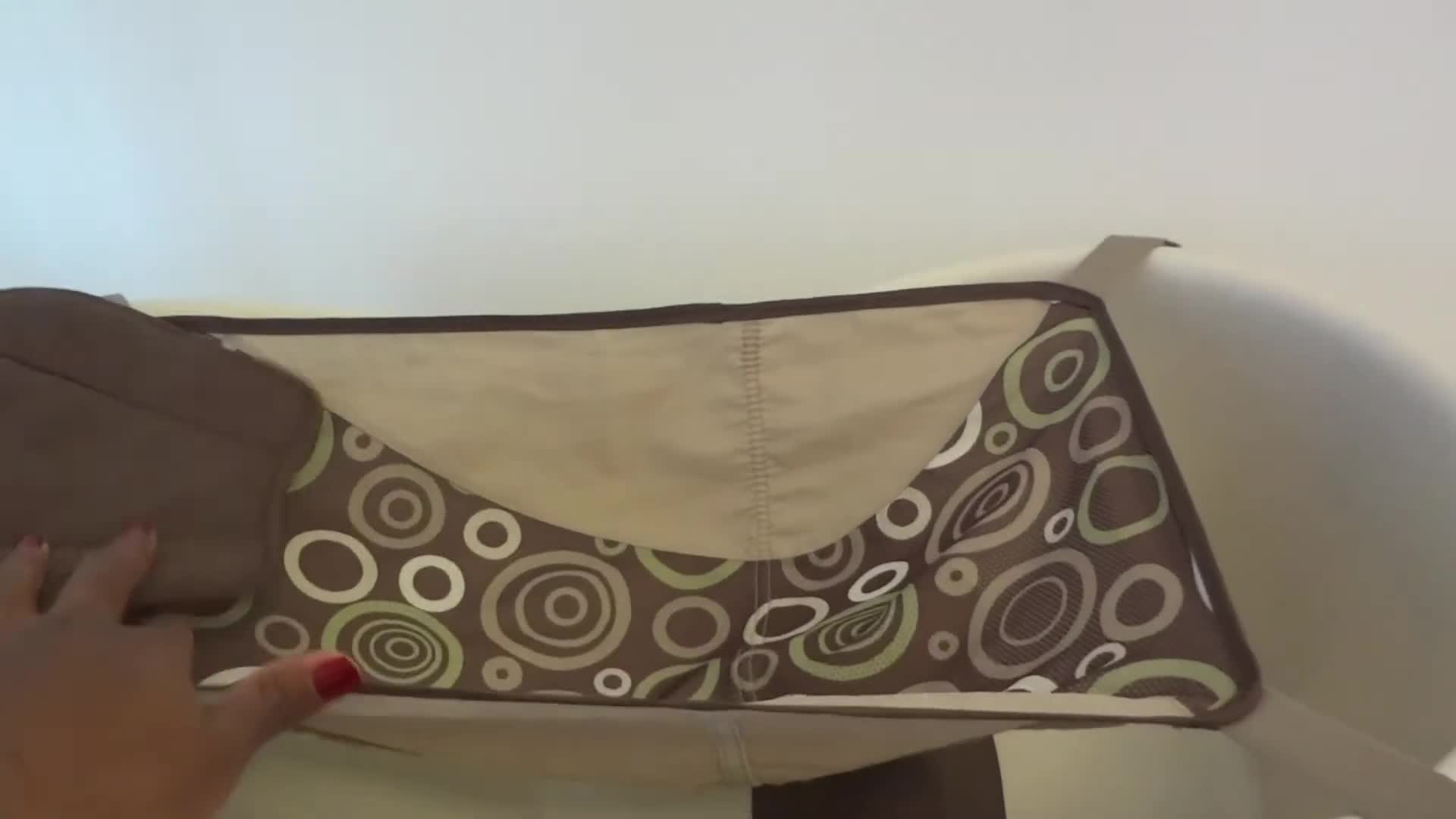 Baby in the sling, showcasing the newborn stage.