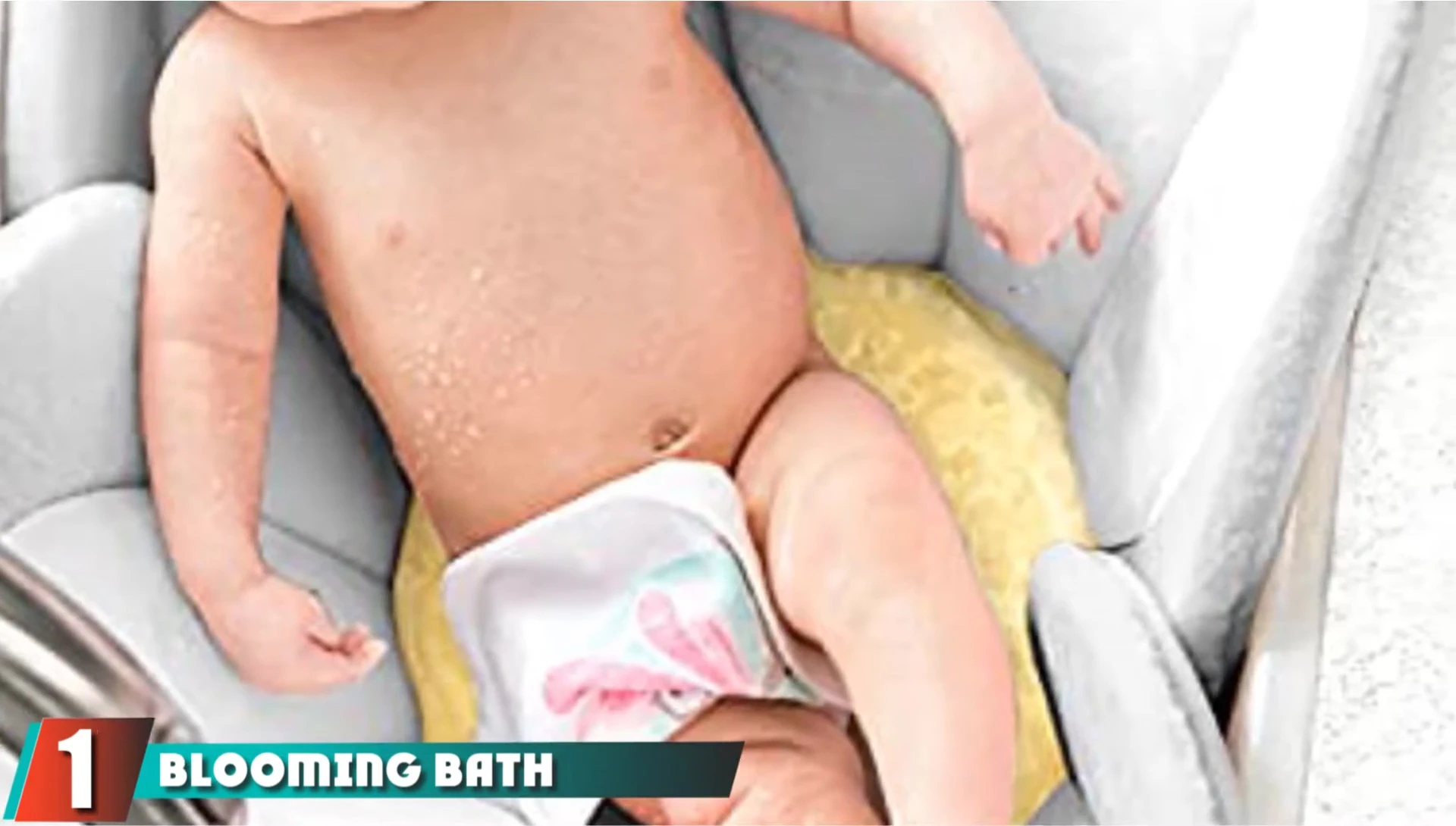 Baby comfortably seated in the Blooming Bath Lotus Baby Bath Seat.