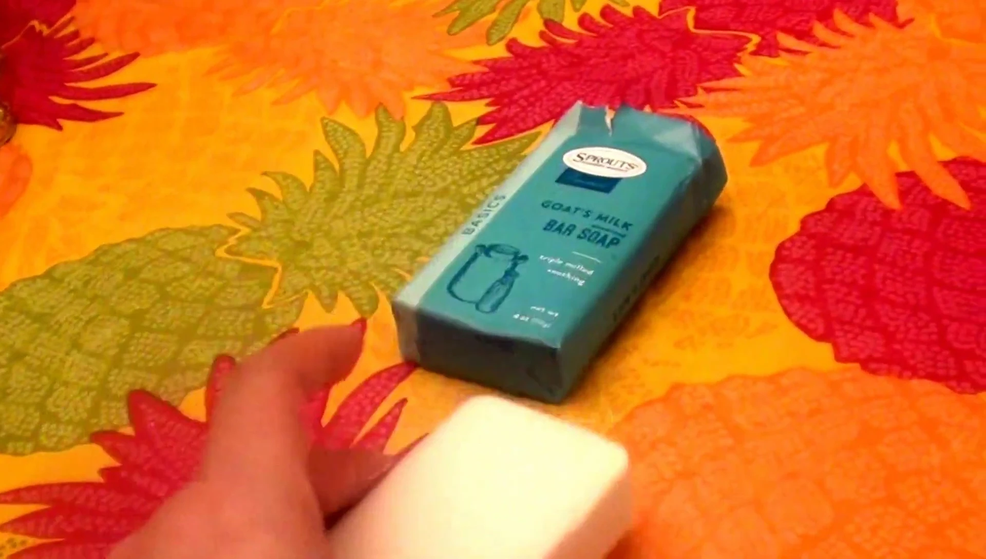 The reviewer holding the soap bar, summing up her thoughts.