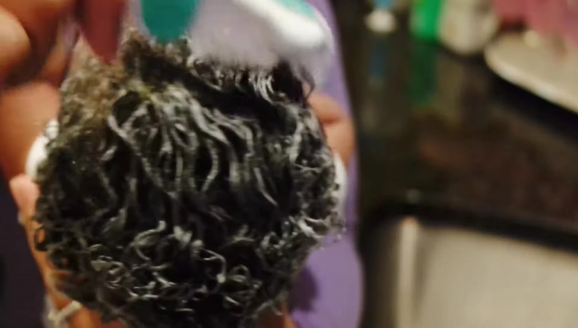Detangling baby's hair with a baby comb.