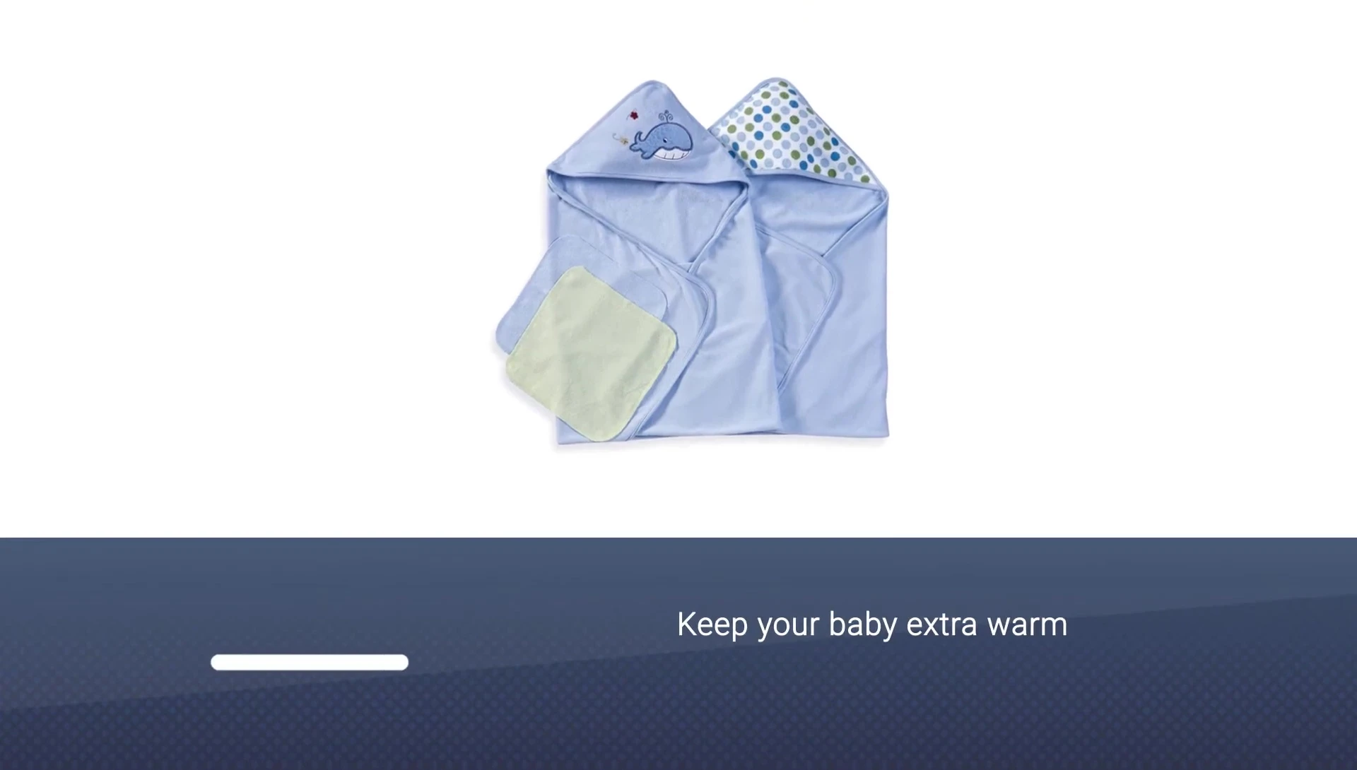 A baby snuggled in a Spa Silk hooded towel after bath time.