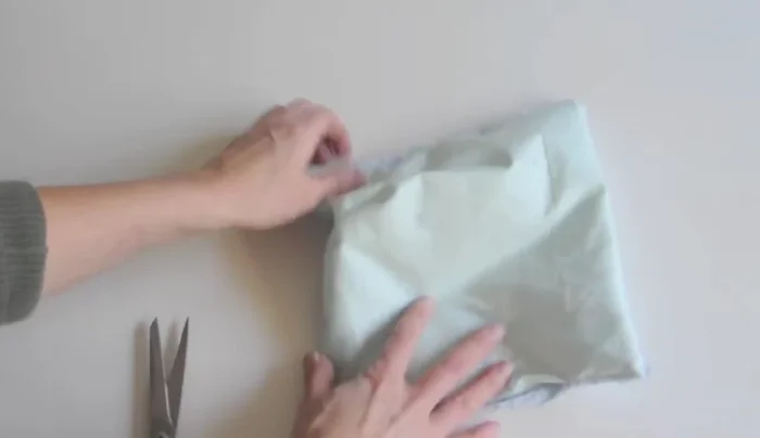 Iron the washcloth flat.