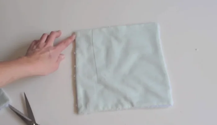 Create an 'X' in the center of the washcloth by quilting it to prevent the layers from separating. 