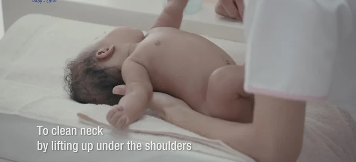 Clean neck: Lift baby up under the shoulders and dry her well.