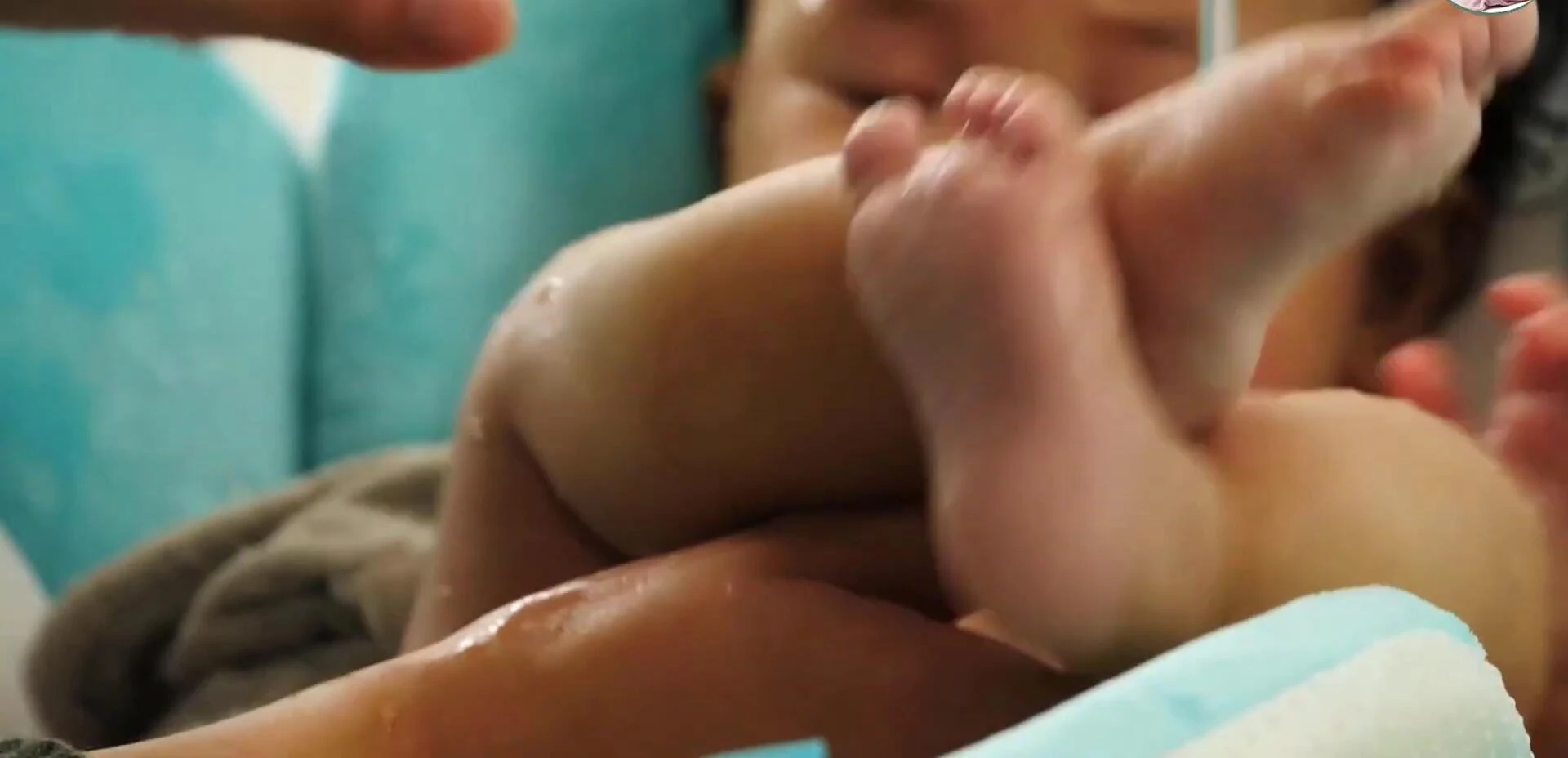 Baby comfortably nestled within the Blooming Bath Flow Pad.