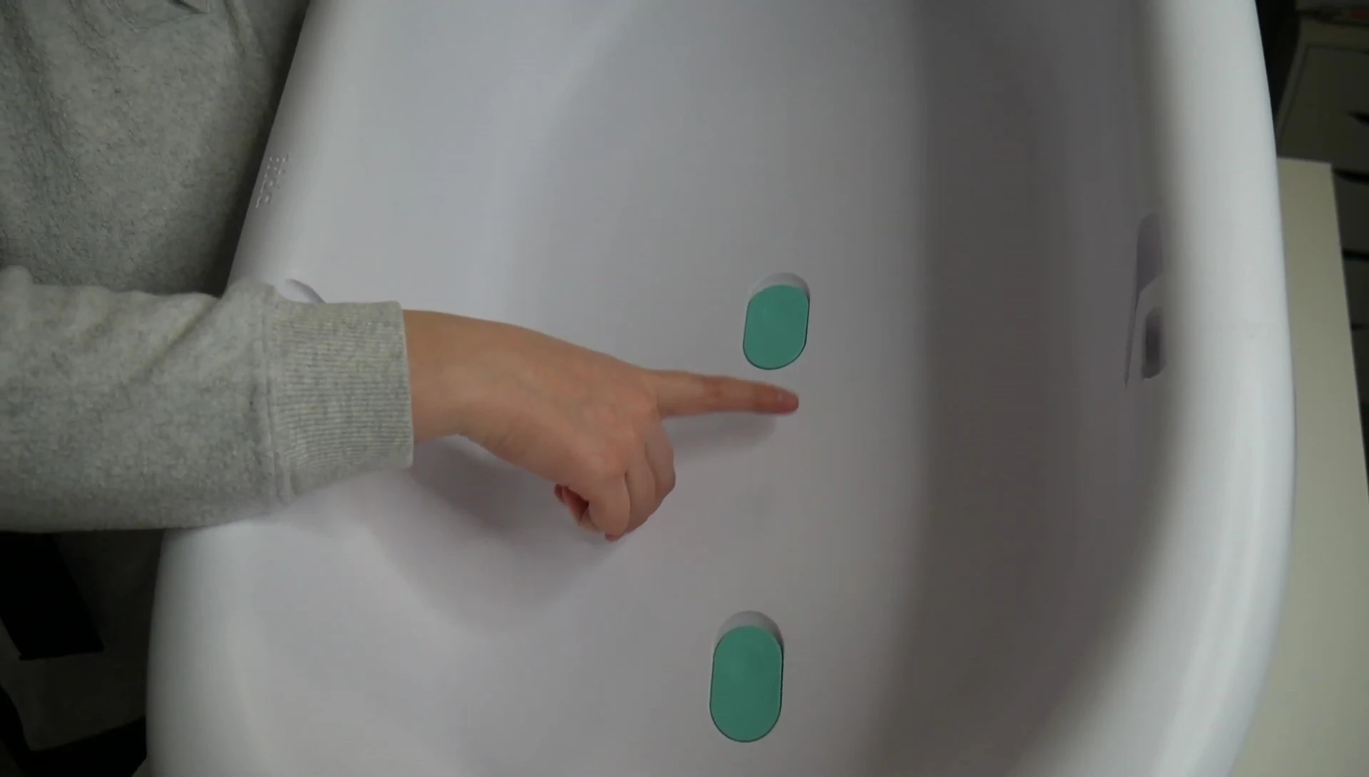Close-up view of the drainage plugs and drying hook.