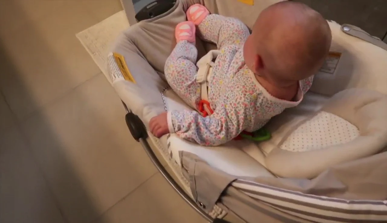 Lila demonstrating her ability to grab and hold objects.