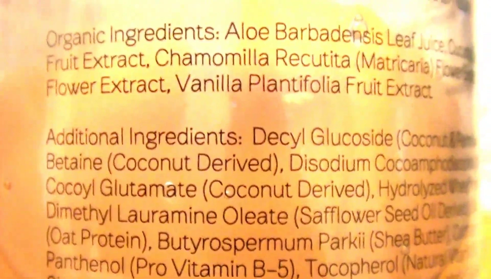 The reviewer showing the ingredient list on the bottle.