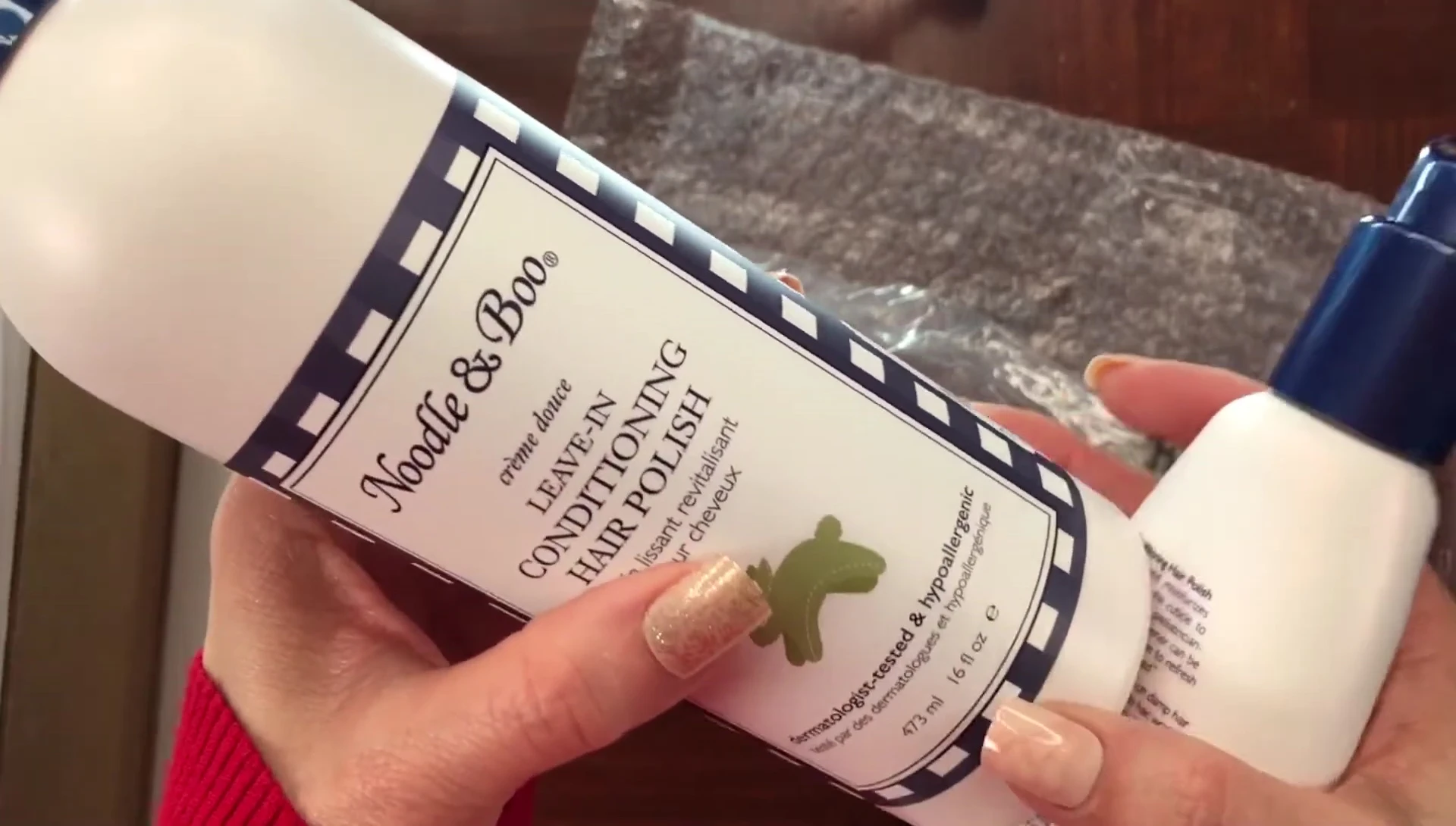 An empty bottle of the leave-in conditioner, indicating repeat use.