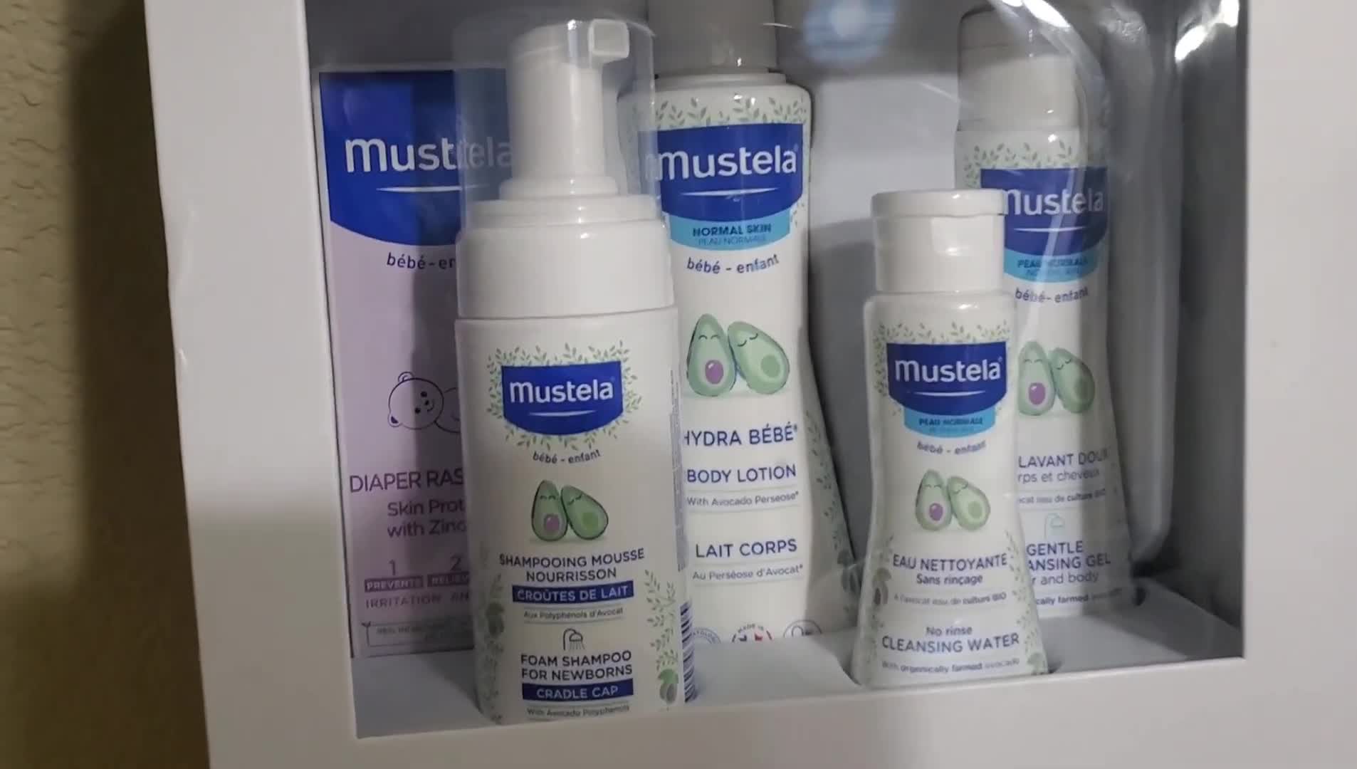 The Mustela newborn arrival set shown on the table.