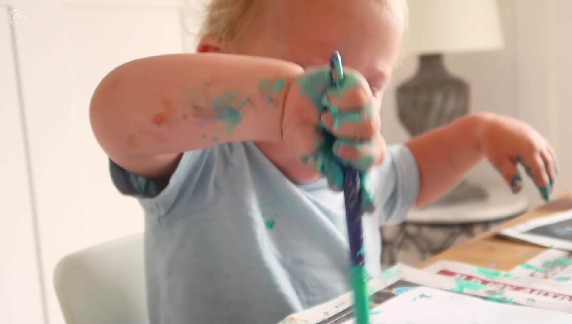 Baby's hands covered in paint