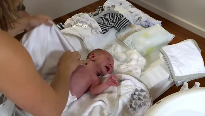 Secure baby: Place baby in a safe location (cot, change mat) while preparing the bath.