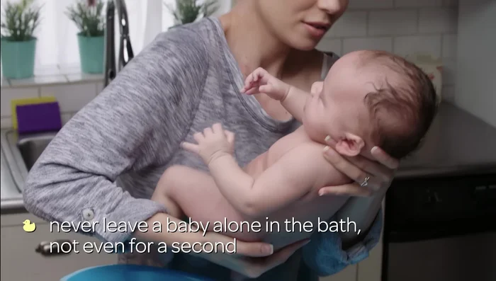 Gently place your baby in the tub, supporting their head and neck.