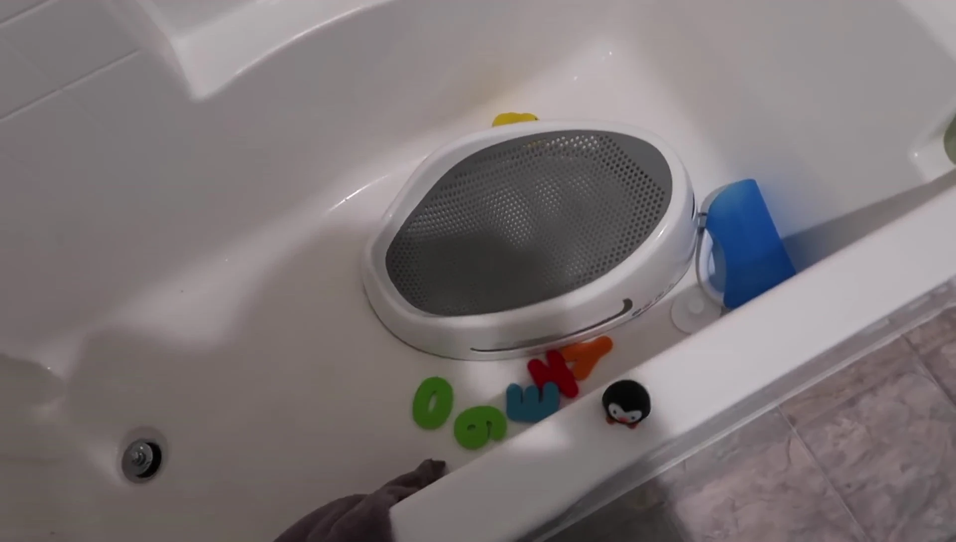Baby bathtub with towel.