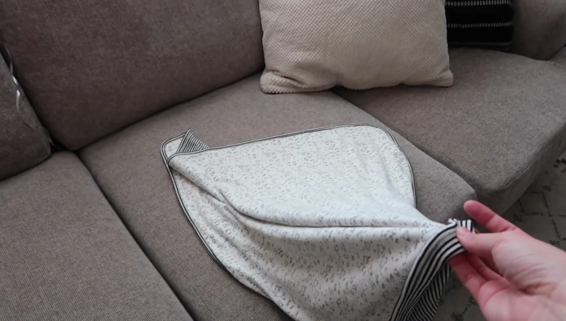 Baby swaddled in a stretchy blanket.