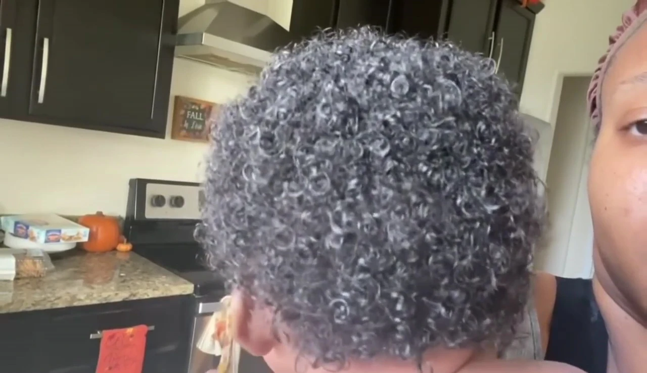 Applying Camille Rose leave-in conditioner
