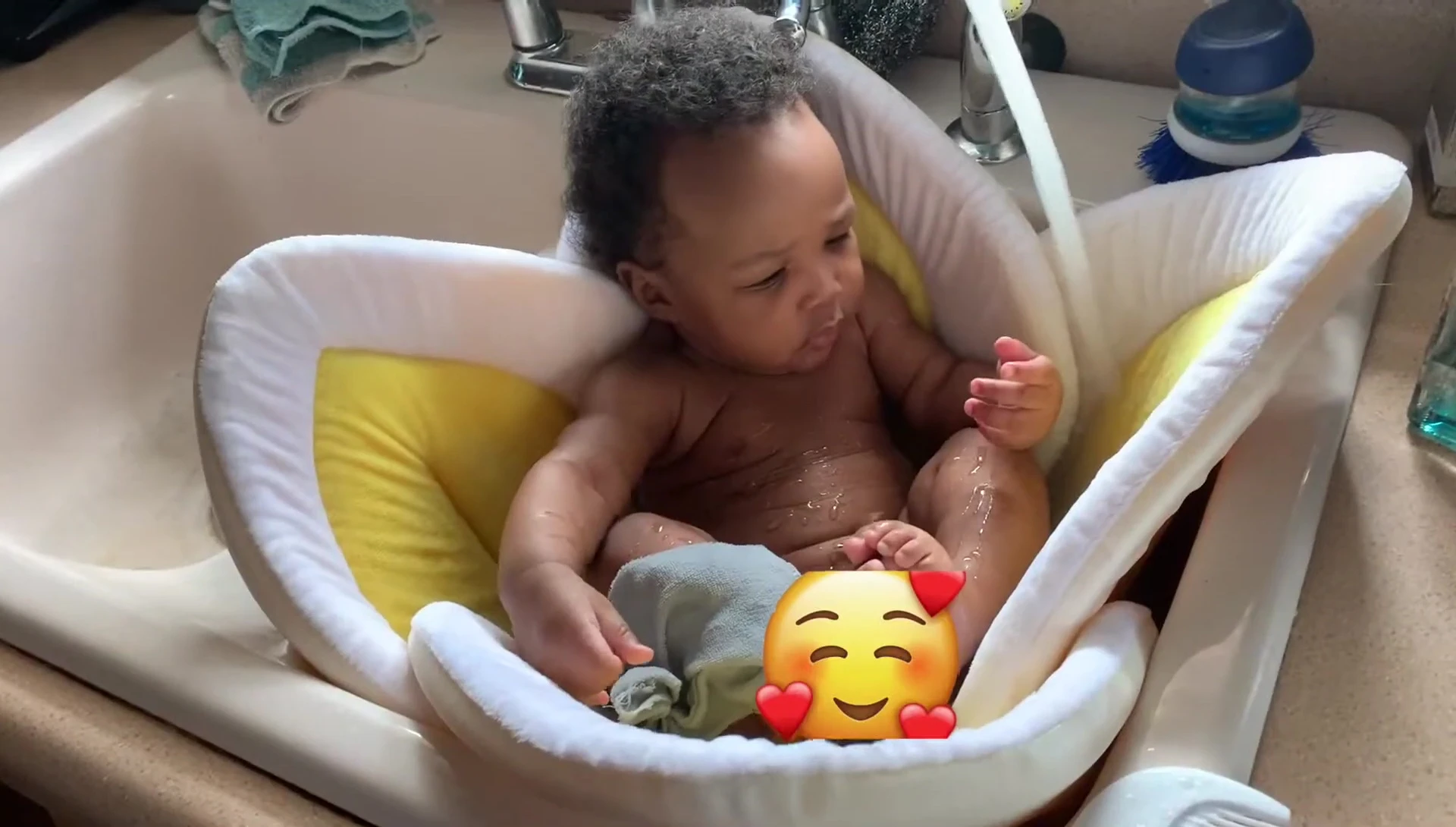 Baby comfortably positioned in the Blooming Baby Bathtub