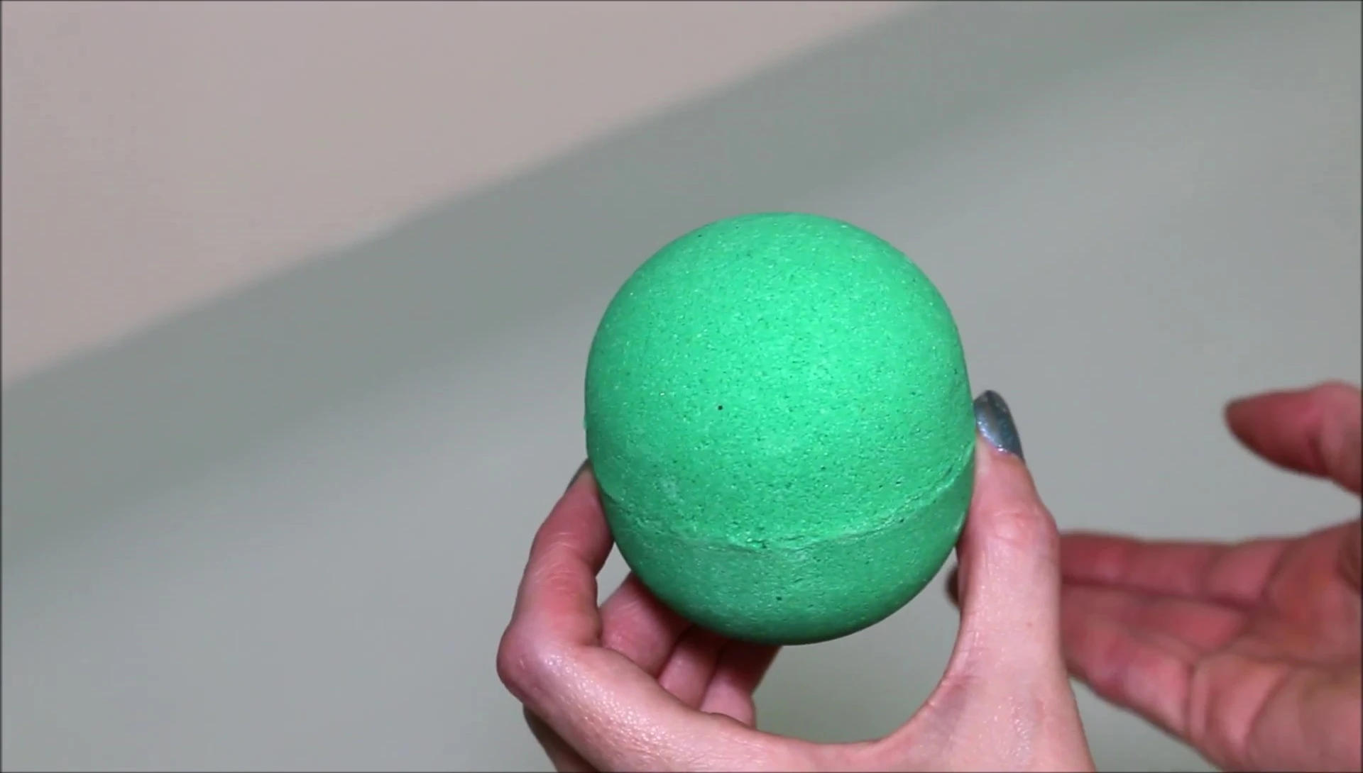 Close-up of the Harvest Moon bath bomb, showcasing its vibrant green color.