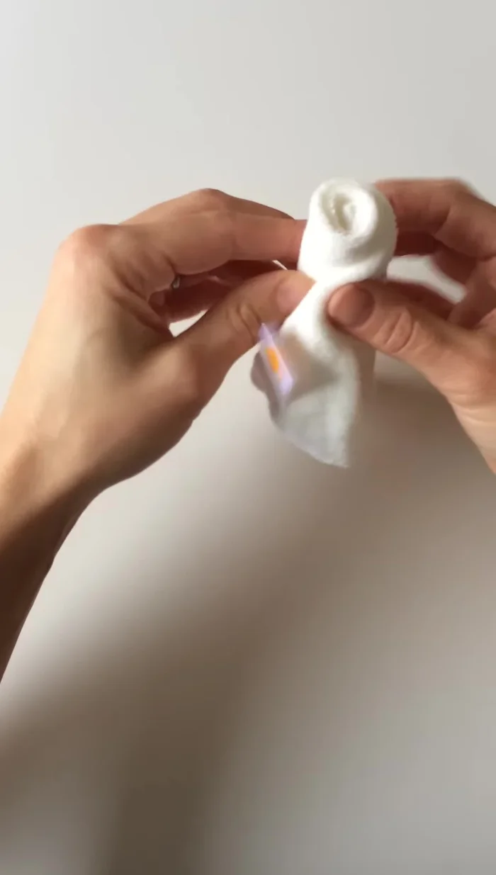 Continue folding in the same direction, folding the top down by about a quarter inch.