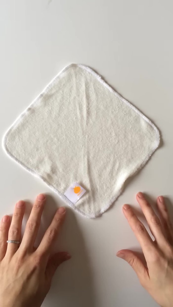 Lay out your washcloth in a diamond shape and fold it in half with the tag at the bottom.