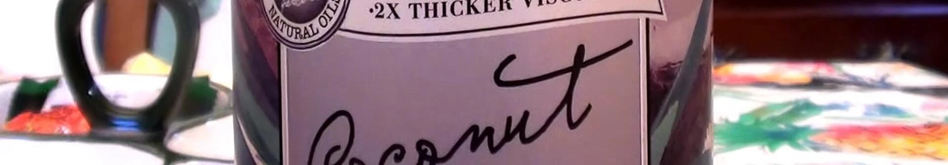 The speaker holds up the bottle and zooms in on the label.