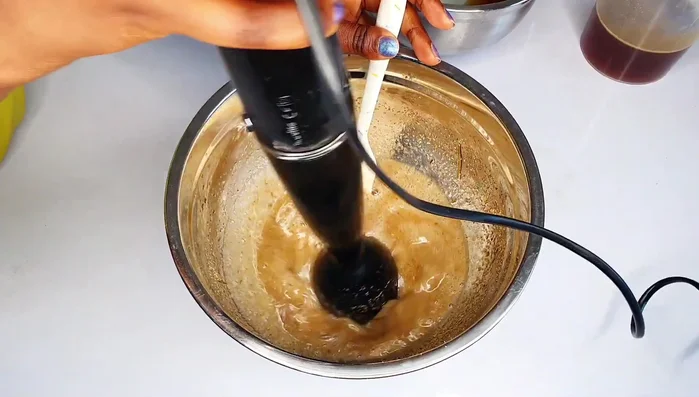 Melt shea butter, palm oil, and argan oil together.