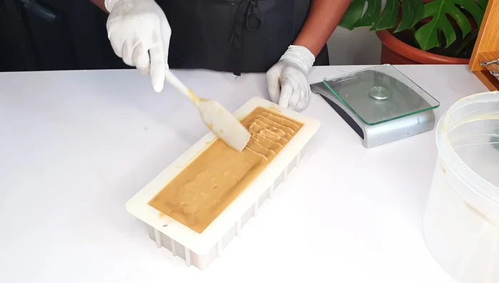Pour the mixture into a mold and lightly texture the top (optional).