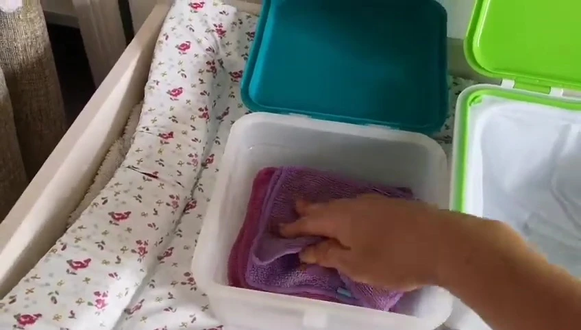 Squeezing out a used wipe.