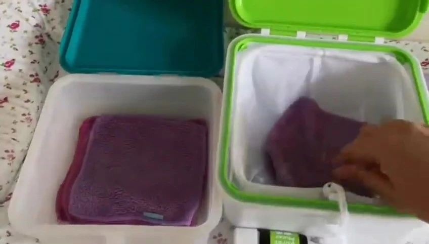 Transferring used wipes to the mucky wipes container.