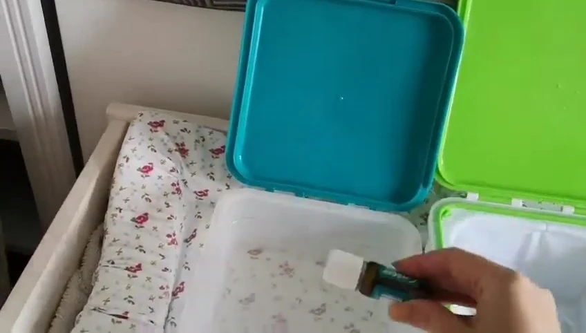 Adding essential oils to the fresh wipes container.
