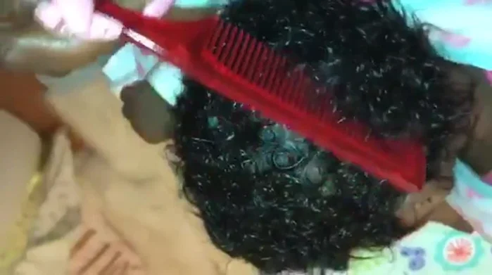 Wipe through the hair with a damp washcloth to remove any flakes of cradle cap or dandruff.