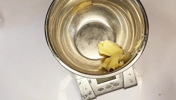 Combine Oils: Measure and combine melted shea butter with palm kernel oil and olive oil.