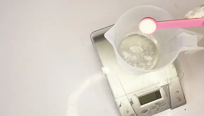 Add Sodium Lactate & Sugar to Lye Solution: Add measured sodium lactate and sugar to the cooled lye solution and mix until completely melted.