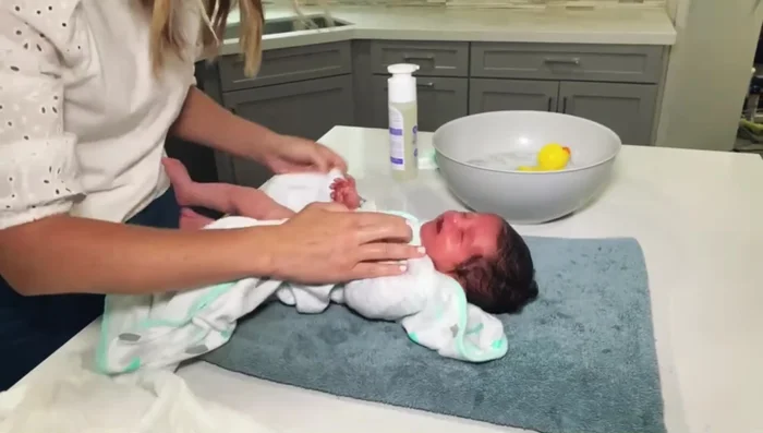Wash diaper area with a clean washcloth. Pay close attention to creases and folds.