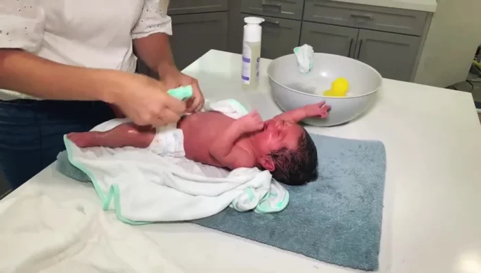 Wash diaper area with a clean washcloth. Pay close attention to creases and folds.