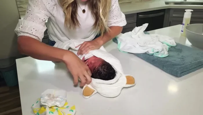 Dress baby and brush hair.